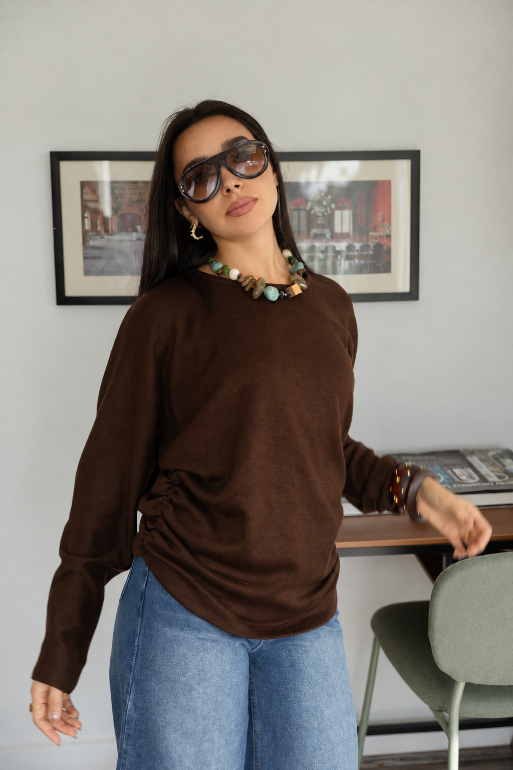 Woman_in_sunglasses_warm_modern_interior.png